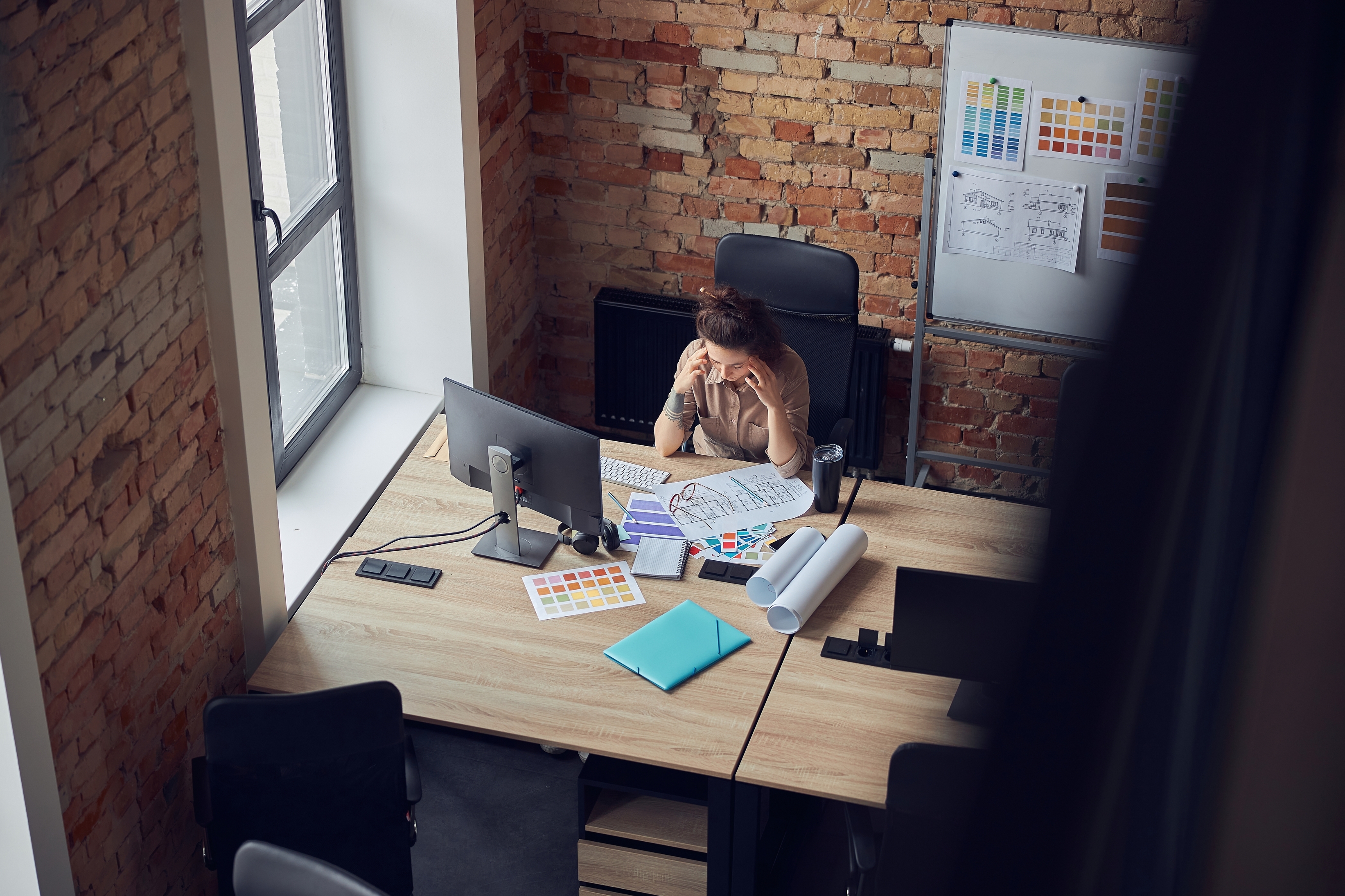 Overwhelmed employee struggles with CRM adoption in modern office