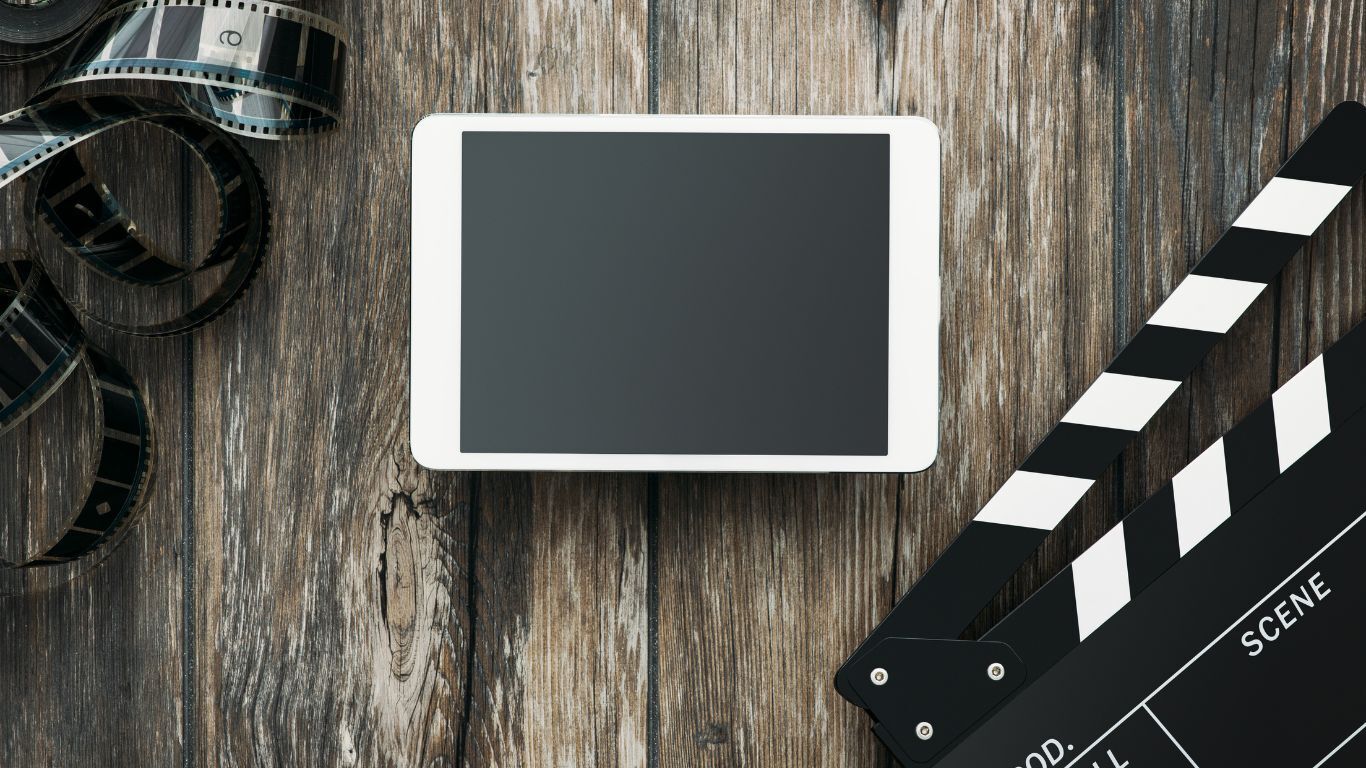 Film slate, reel and tablet representing planning and production of video testimonials for contractor events.