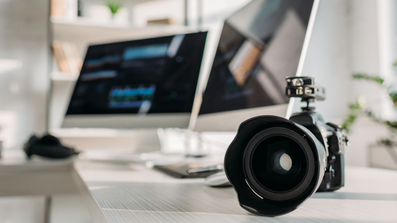 Camera and computer equipment prepared for recording video testimonials at a trade show booth.