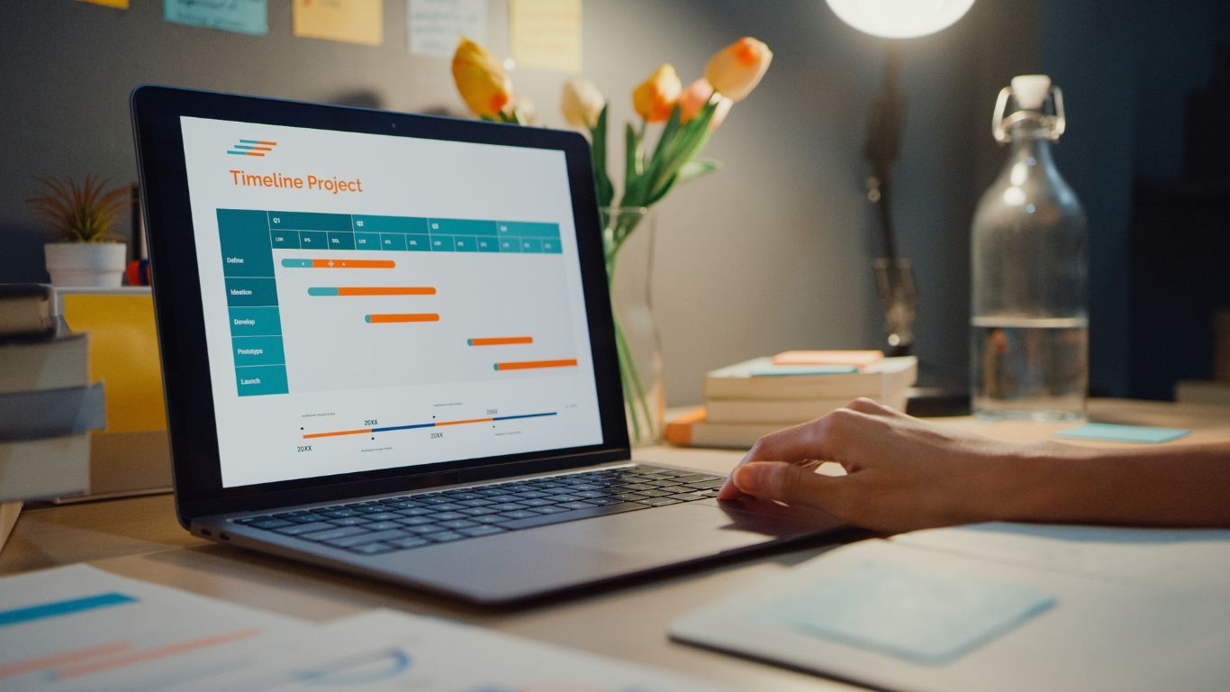 Laptop showing a project timeline and schedule used to help reduce scheduling conflicts.