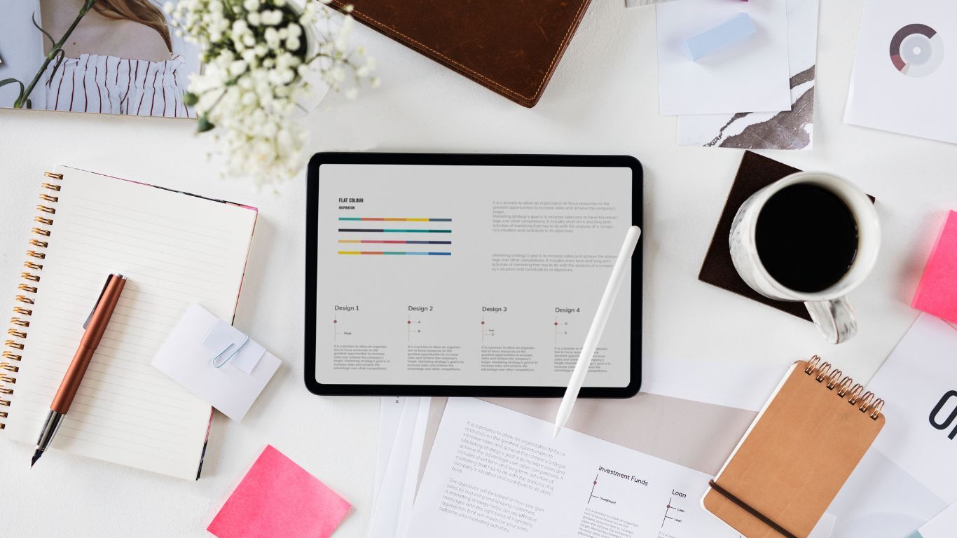 Tablet, notebook, and reports arranged as contractor sales tools for planning and reviewing sales activity.