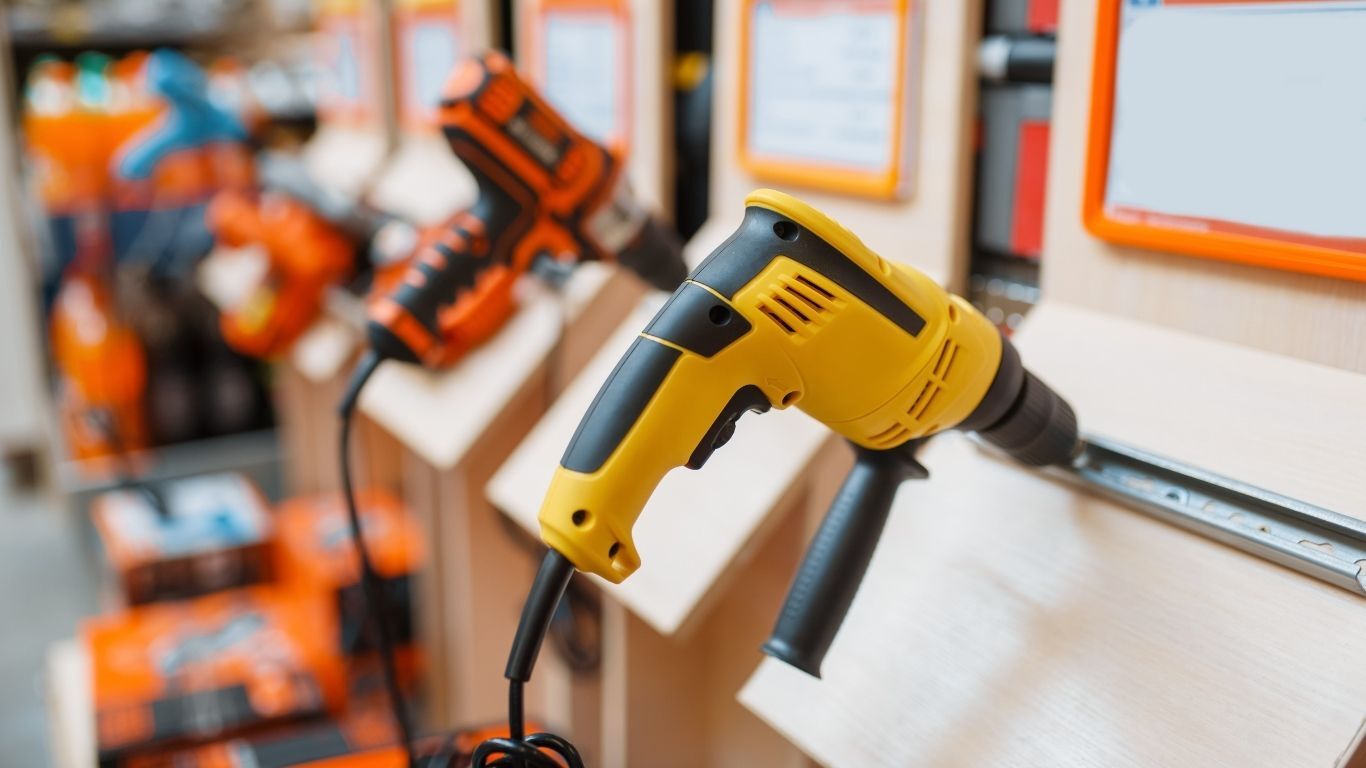 Power drills displayed at a home improvement trade show booth before attendees arrive.