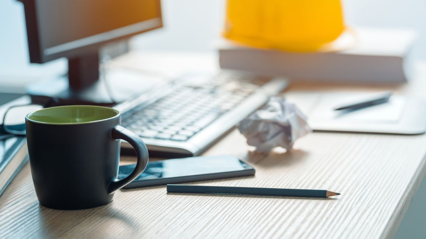 Contractor workspace illustrating disconnected contractor software and fragmented office workflows.