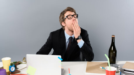 Businessman yawing at workplace near cupcake and p 2023 11 27 05 13 59 utc